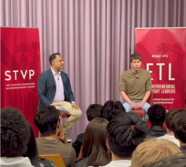 Mehran Samahi (right) and Sam Altman (left) sitting on a stage and facing a crowd in NVIDIA Auditorium.